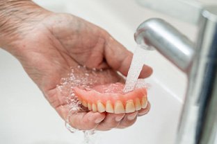 Dentures being rinsed