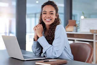 Woman smiling while working in office