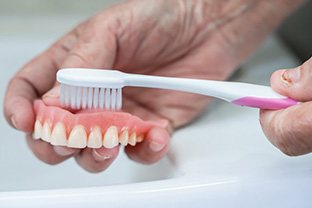 Dentures being brushed