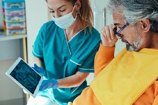 Dentist and patient looking at X-rays