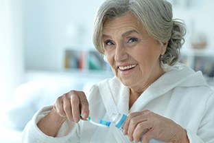 Dentures patient in Peabody about to do their oral hygiene routine