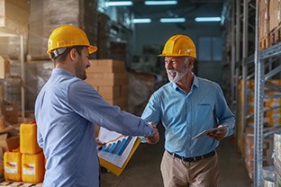 Dentures patient in Peabody shaking hands with a manager