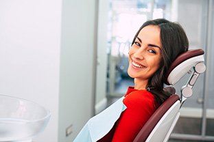 A smiling woman sitting in a dentist’s chair